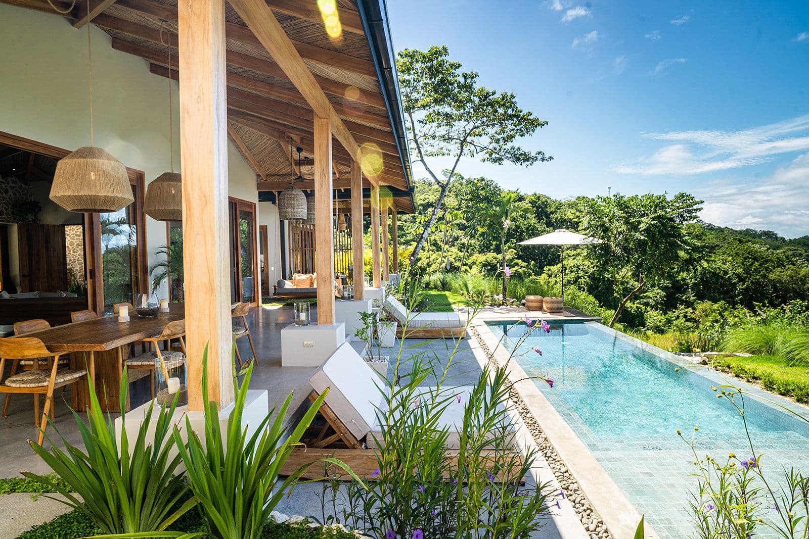 The pool and open-air living space, wrapped in jungle